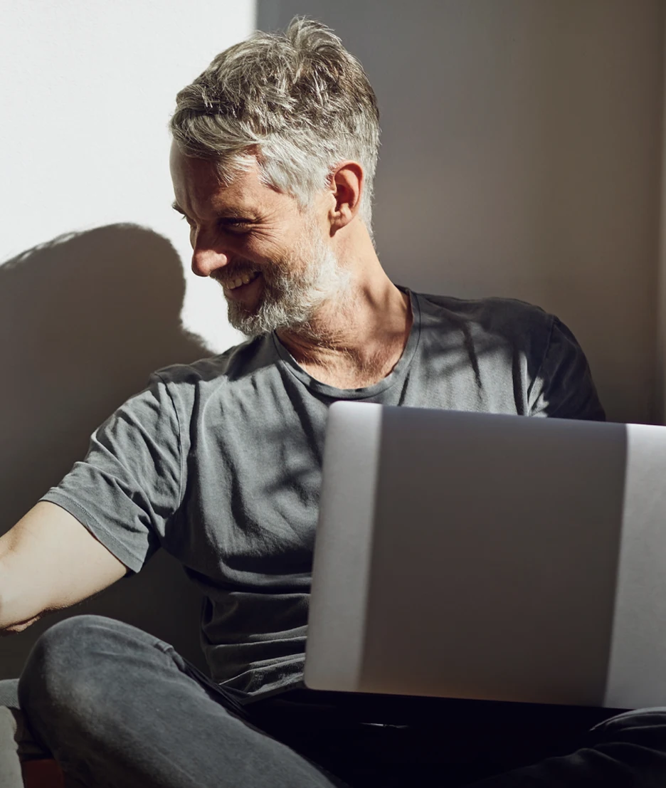 An experienced trader looking at their laptop